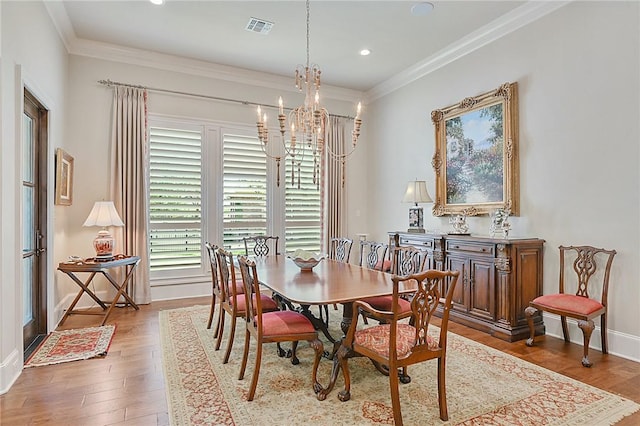 5205 Bourrone Ct, Bryan, TX 77802 - dining space featuring a chandelier, wood finished floors, ornamental molding, recessed lighting, and baseboards
