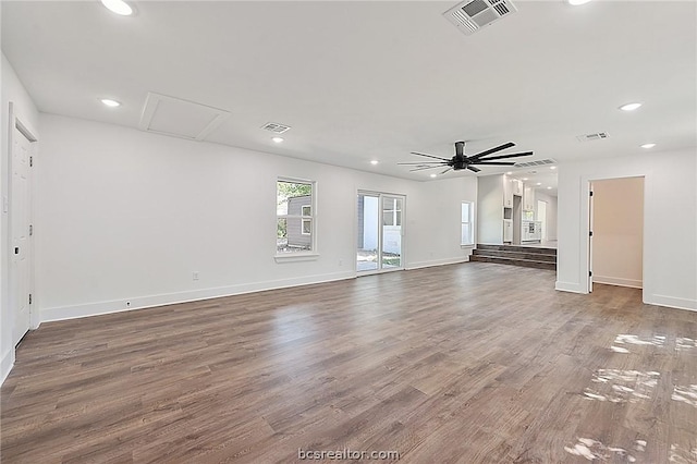 unfurnished living room with dark hardwood / wood-style floors and ceiling fan