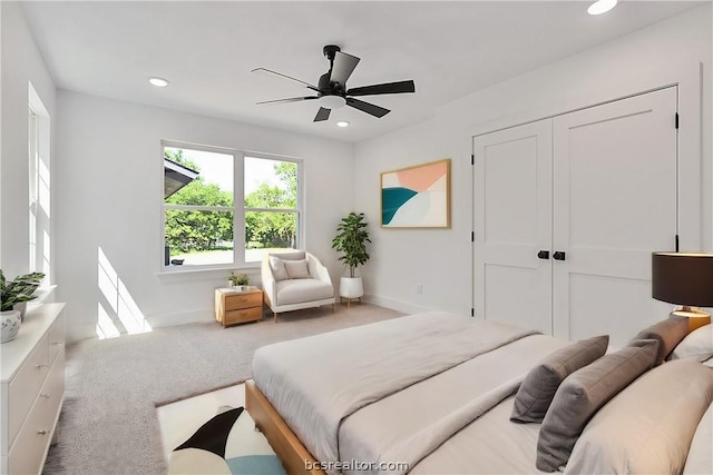 bedroom with carpet, a closet, and ceiling fan