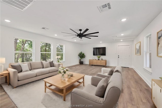 living room featuring ceiling fan and light hardwood / wood-style floors