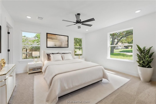 bedroom with ceiling fan and light colored carpet