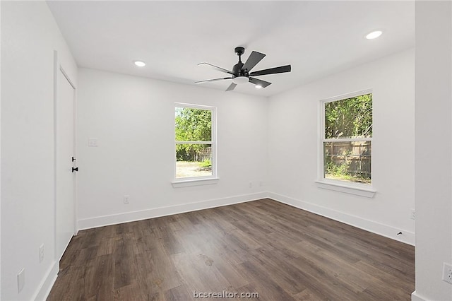 unfurnished room with dark hardwood / wood-style flooring and plenty of natural light