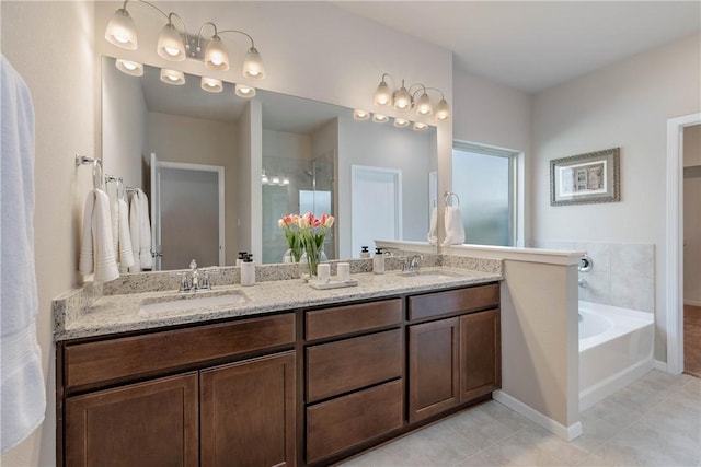 6409 Raleigh Loop, College Station, TX 77845 - bathroom featuring double vanity, a shower stall, a garden tub, tile patterned floors, and baseboards