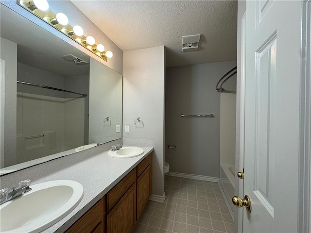 full bathroom with toilet, vanity, a textured ceiling, and washtub / shower combination