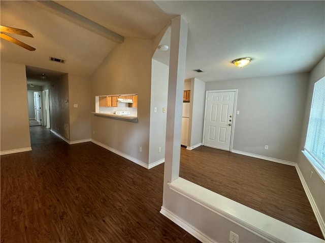 foyer with ceiling fan, dark hardwood / wood-style flooring, and vaulted ceiling with beams