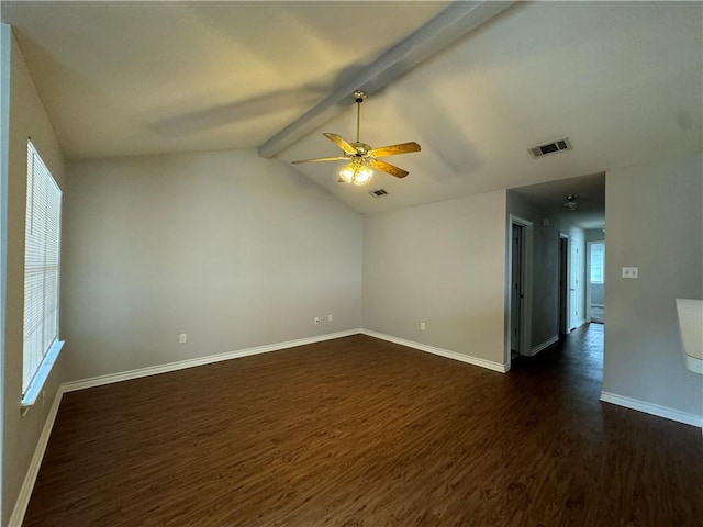 empty room with ceiling fan, a healthy amount of sunlight, vaulted ceiling with beams, and dark hardwood / wood-style floors