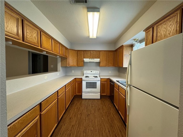 kitchen featuring white appliances, dark hardwood / wood-style flooring, and sink