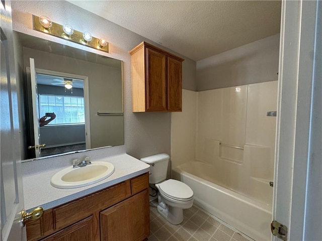 full bathroom with a textured ceiling, ceiling fan, toilet, shower / bathing tub combination, and vanity