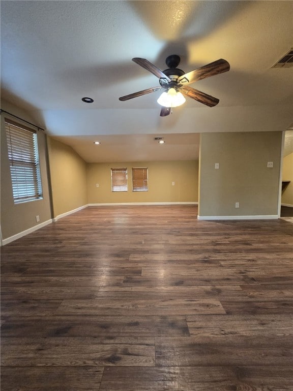 empty room with ceiling fan and dark wood-type flooring