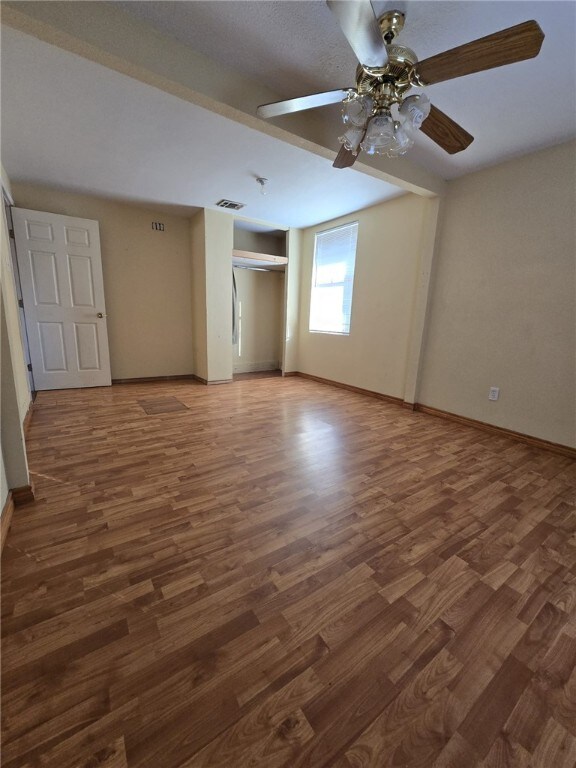 spare room with ceiling fan and dark hardwood / wood-style floors