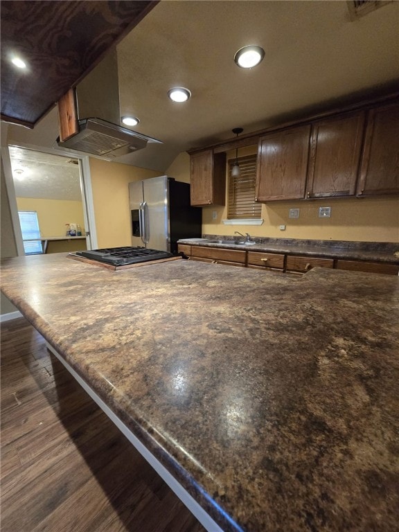 kitchen with dark hardwood / wood-style flooring and stainless steel refrigerator with ice dispenser