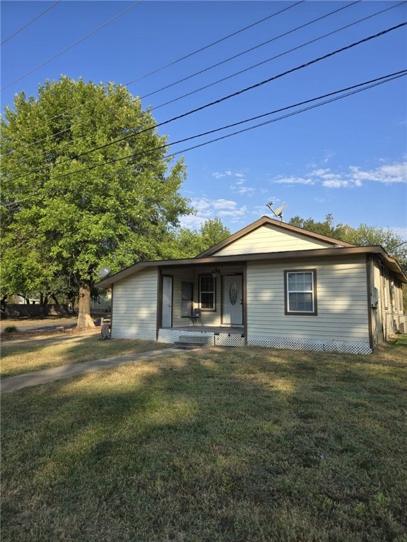 rear view of house with a yard and covered porch