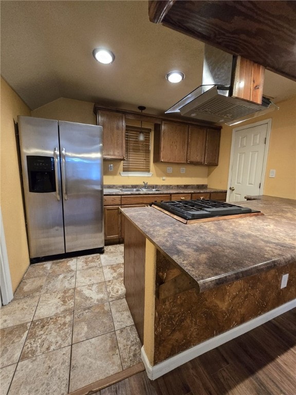 kitchen with stainless steel refrigerator with ice dispenser, light hardwood / wood-style flooring, kitchen peninsula, island exhaust hood, and gas cooktop