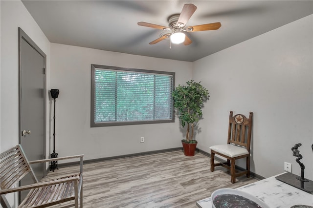 sitting room featuring ceiling fan and light wood-type flooring