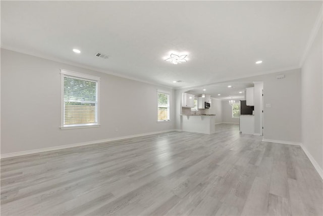 301 S Hutchins St, Bryan, TX 77803 - unfurnished living room with ornamental molding, baseboards, light wood-style flooring, and recessed lighting