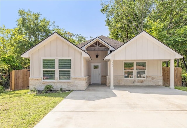 301 S Hutchins St, Bryan, TX 77803 - modern farmhouse style home with board and batten siding, stone siding, concrete driveway, and roof with shingles