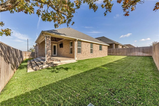 rear view of house with a yard and a patio area