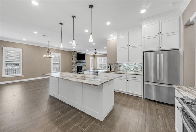 kitchen featuring light stone countertops, white cabinetry, dark wood-type flooring, and appliances with stainless steel finishes