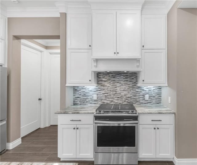 kitchen with white cabinets, decorative backsplash, light stone countertops, and appliances with stainless steel finishes