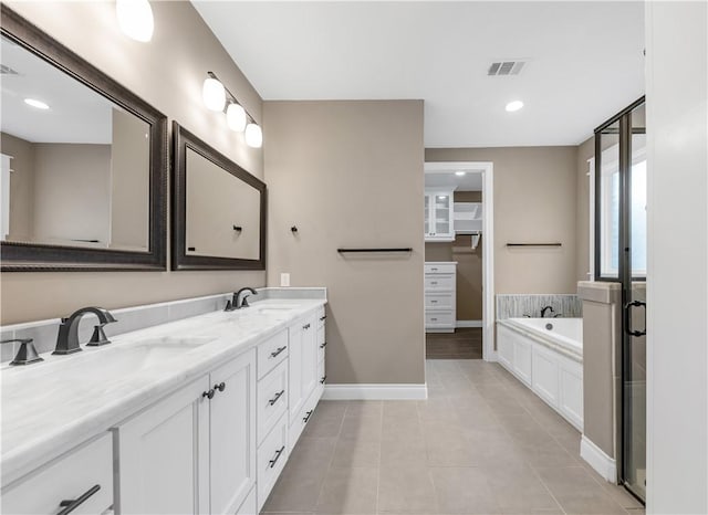 bathroom featuring shower with separate bathtub, vanity, and tile patterned floors