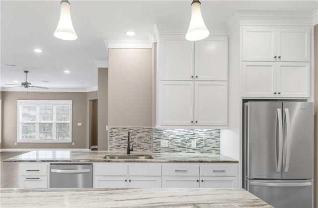 kitchen featuring white cabinets, sink, hanging light fixtures, ceiling fan, and stainless steel appliances