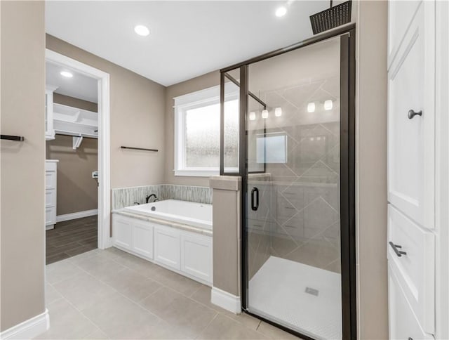 bathroom featuring tile patterned flooring and separate shower and tub