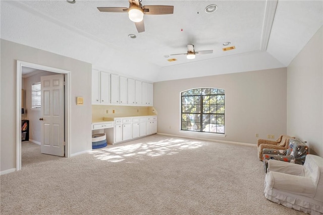 interior space with light carpet, ceiling fan, and lofted ceiling