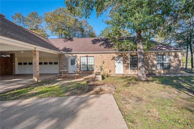 single story home featuring a garage and a front lawn