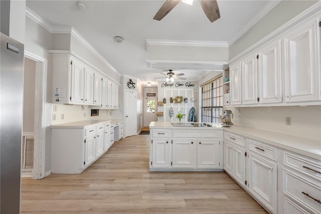 kitchen with ceiling fan, kitchen peninsula, light hardwood / wood-style floors, white cabinets, and ornamental molding