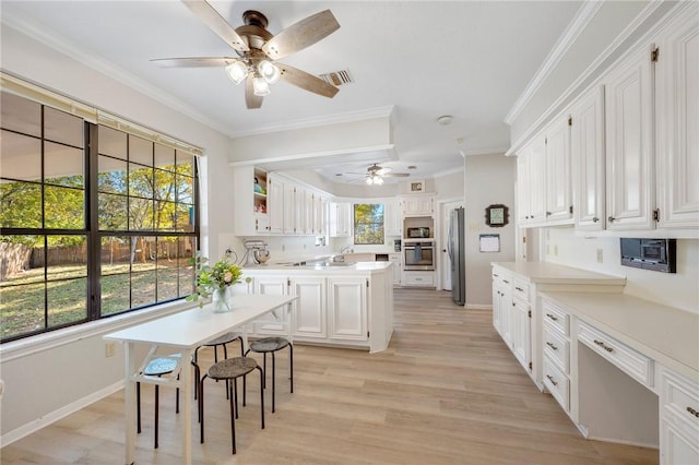 kitchen with white cabinetry, ceiling fan, light wood-type flooring, appliances with stainless steel finishes, and ornamental molding