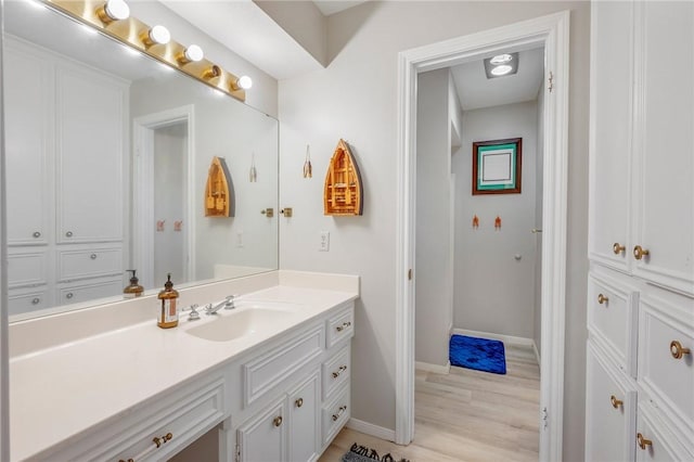 bathroom with vanity and hardwood / wood-style flooring