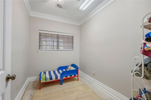 sitting room featuring crown molding and light hardwood / wood-style flooring