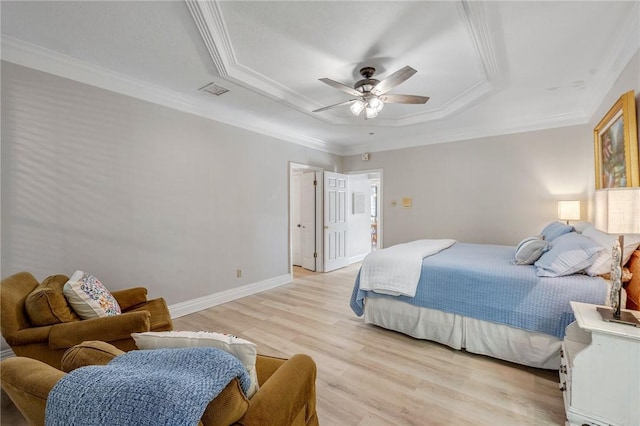 bedroom with a raised ceiling, ceiling fan, light hardwood / wood-style flooring, and crown molding