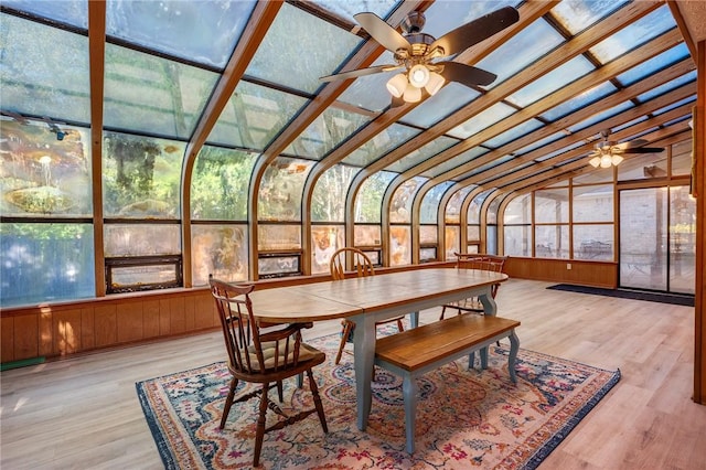 sunroom / solarium with ceiling fan and vaulted ceiling