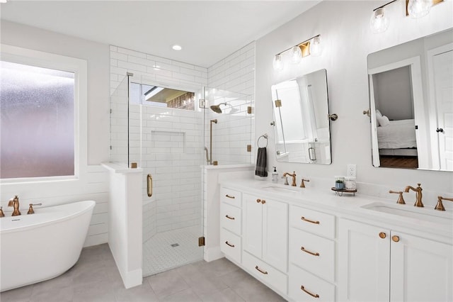 3518 Parmer Creek Ct, College Station, TX 77845 - bathroom featuring a stall shower, double vanity, a freestanding tub, connected bathroom, and tile patterned flooring