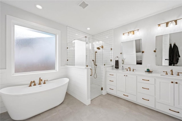3518 Parmer Creek Ct, College Station, TX 77845 - bathroom with tiled shower, double vanity, a freestanding tub, recessed lighting, and tile patterned floors