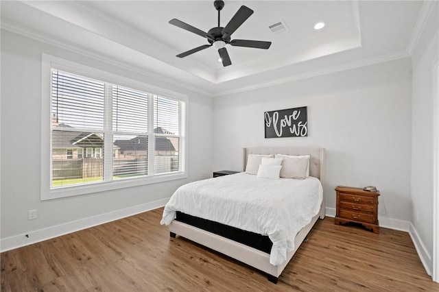 3518 Parmer Creek Ct, College Station, TX 77845 - bedroom featuring a tray ceiling, ornamental molding, wood finished floors, recessed lighting, and a ceiling fan