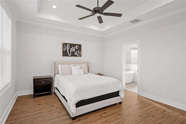 3518 Parmer Creek Ct, College Station, TX 77845 - bedroom with a tray ceiling, multiple windows, wood finished floors, ornamental molding, and recessed lighting