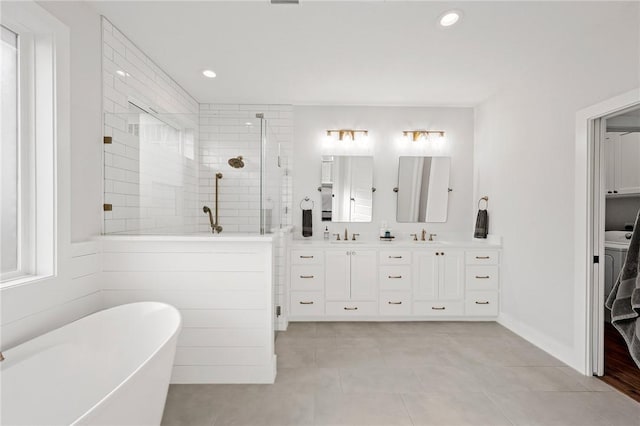 3518 Parmer Creek Ct, College Station, TX 77845 - bathroom featuring double vanity, a shower stall, a soaking tub, tile patterned floors, and recessed lighting
