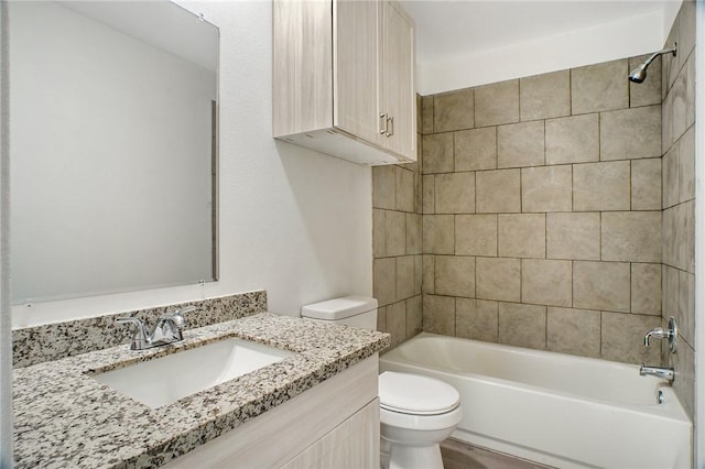 bathroom featuring toilet, vanity, and bathing tub / shower combination