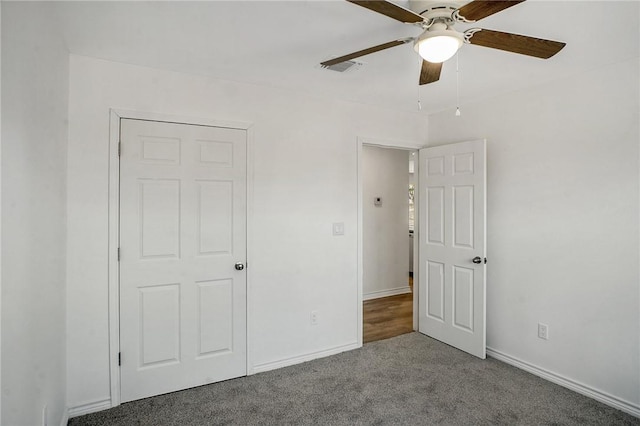 unfurnished bedroom featuring ceiling fan, carpet, visible vents, and baseboards