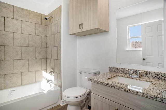 bathroom with shower / bath combination, toilet, and vanity