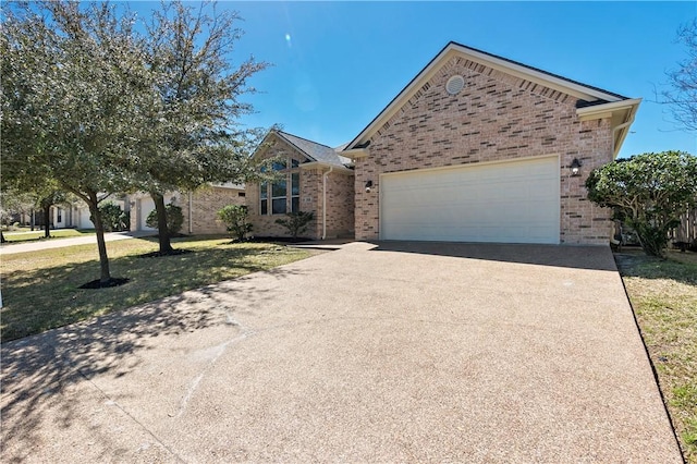 ranch-style house with brick siding, driveway, an attached garage, and a front yard