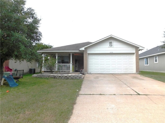 view of front of house featuring covered porch, a garage, and a front lawn