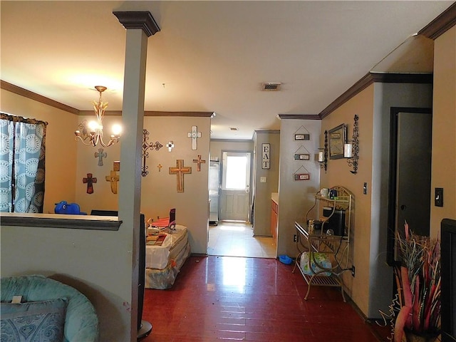 interior space featuring hardwood / wood-style flooring, crown molding, and an inviting chandelier