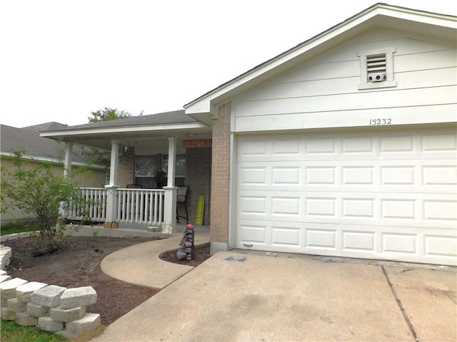 single story home with a porch and a garage