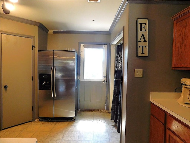 kitchen with stainless steel fridge and crown molding