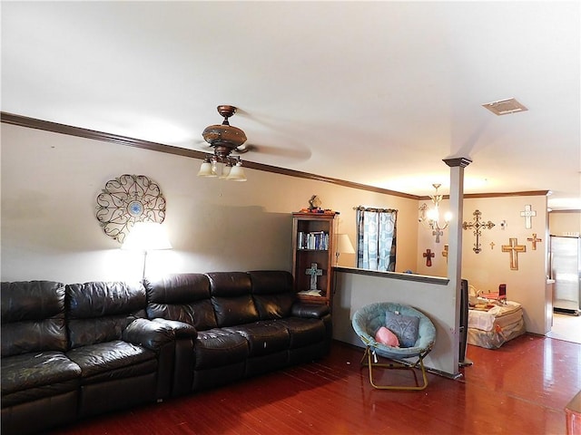 living room with hardwood / wood-style floors, ceiling fan with notable chandelier, and crown molding