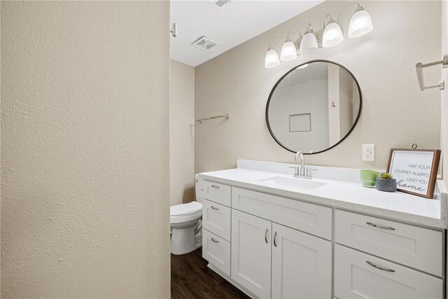 bathroom featuring hardwood / wood-style flooring, vanity, and toilet