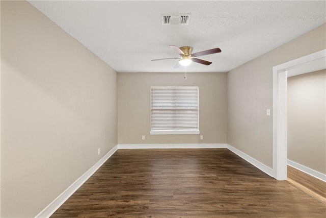 spare room with ceiling fan and dark hardwood / wood-style flooring